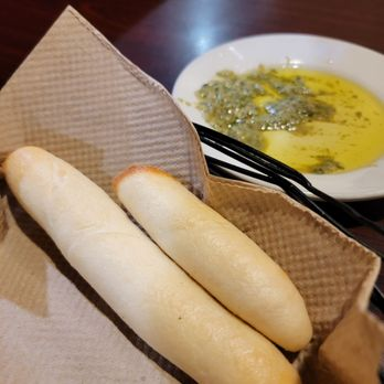 Complimentary breadsticks with olive oil pesto dip