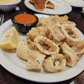 Plate of fried calamari with marinara and lemon