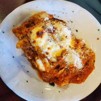 Slice of baked meat lasagna with melted cheese